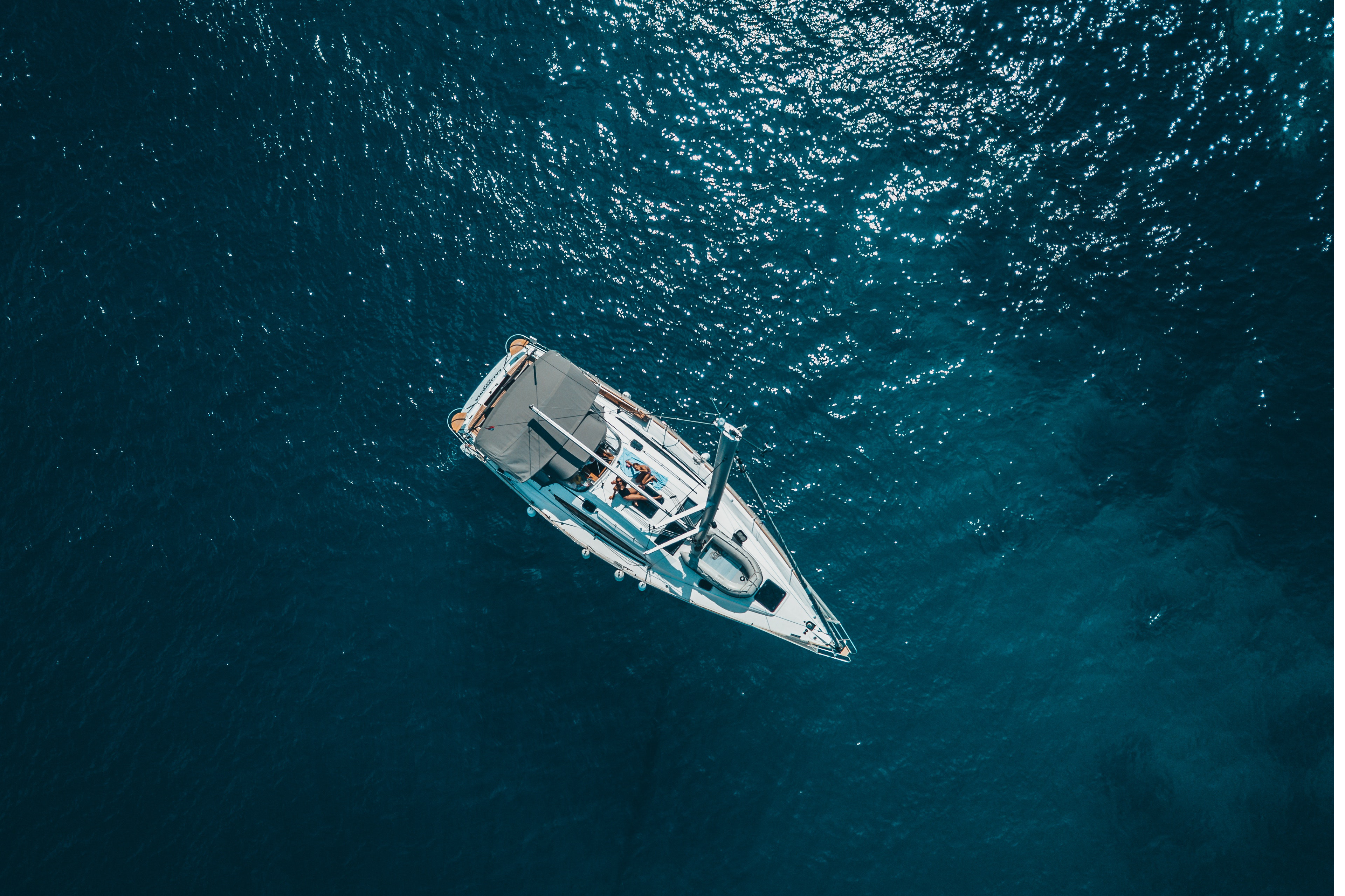 High angle photo of white boat on body of water.