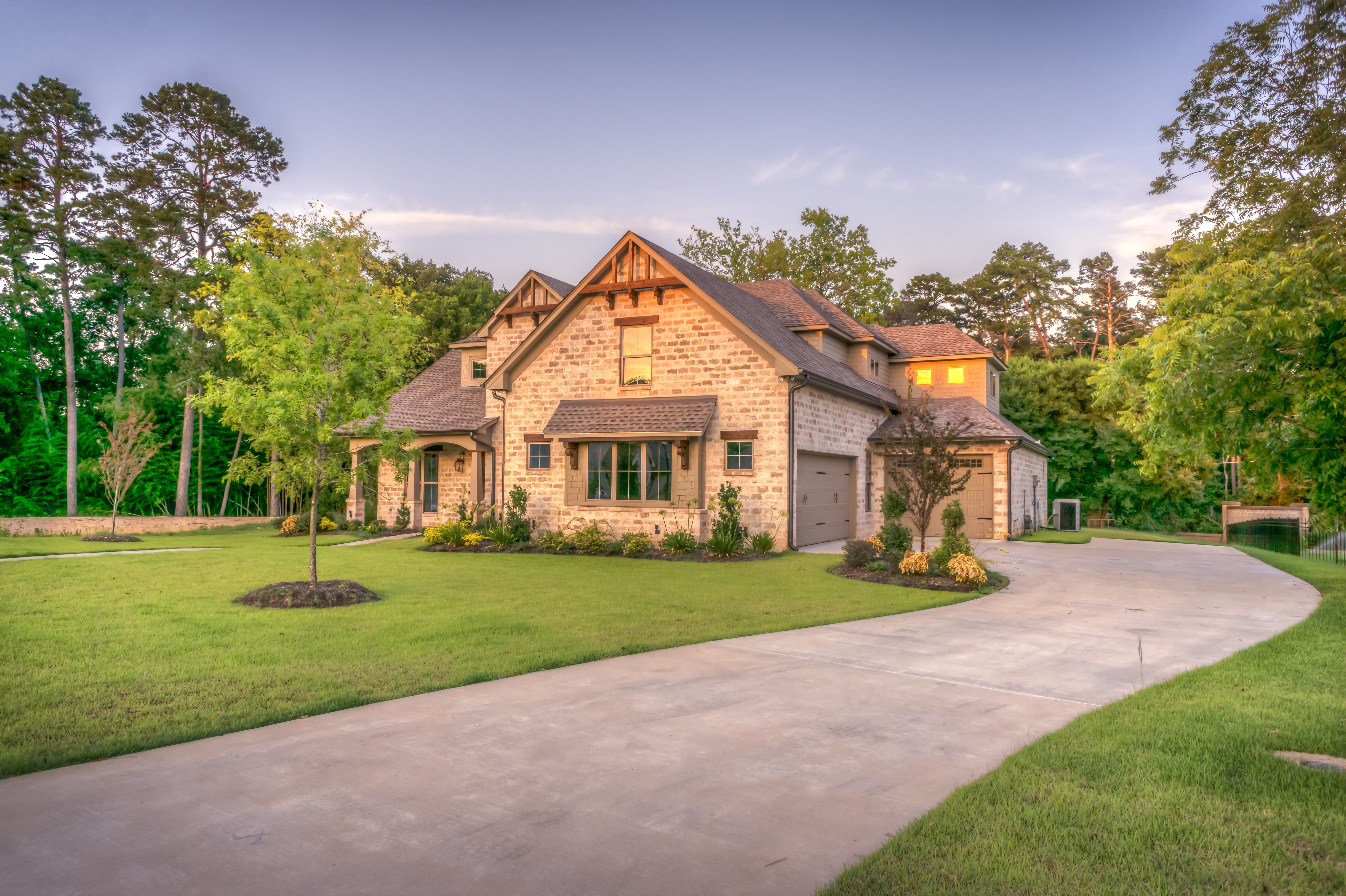 Photo of a house on a wooded lot.