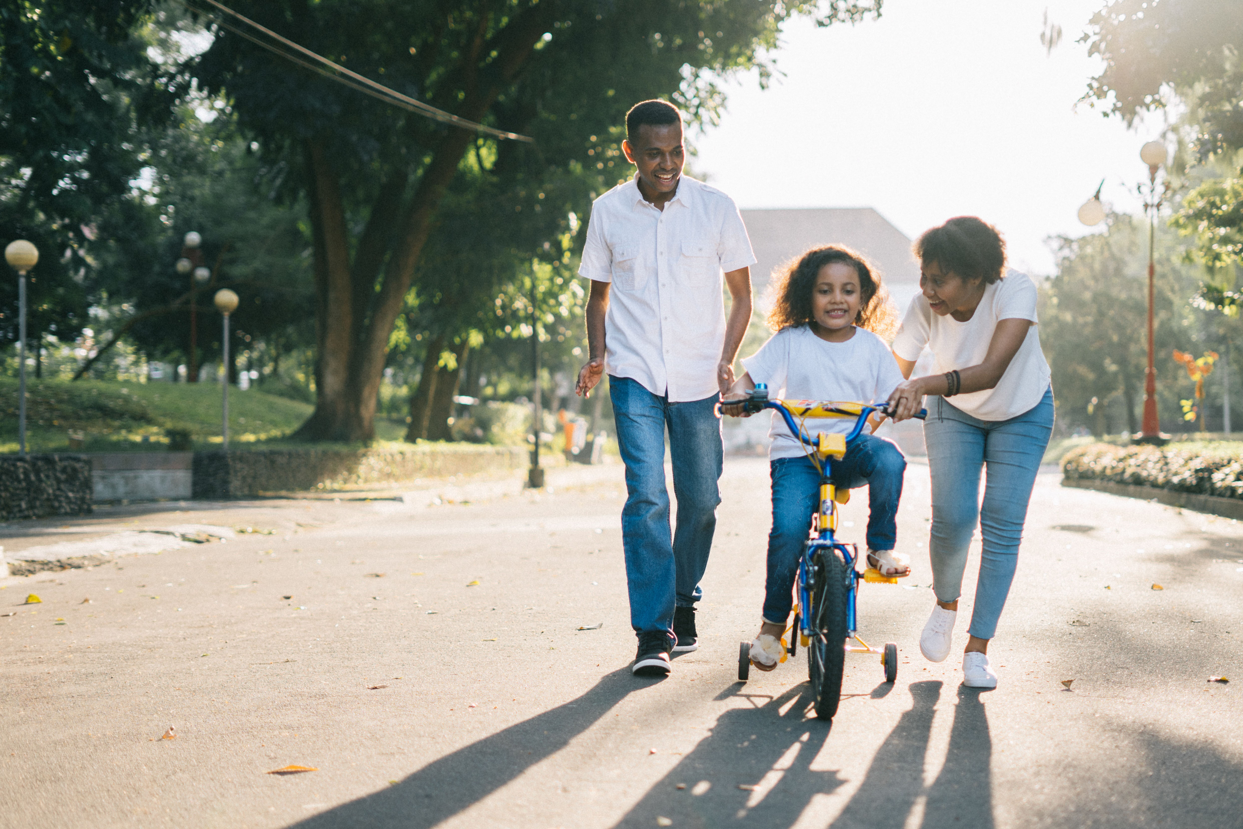Couple with a child rinding a bike.